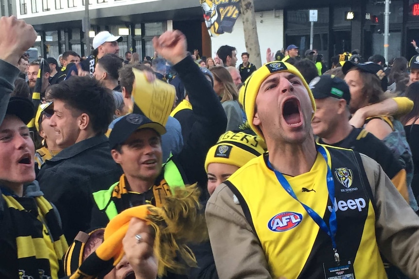 Fans in yellow and black celebrate on Swan Street in Richmond.