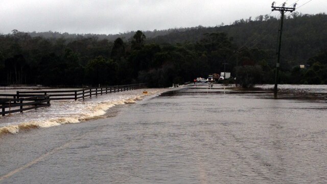 A road is cut off in Rocherlea as floodwaters rise after severe weather lashed northern Tasmania.