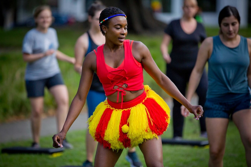 Sheron teaches a dance class.