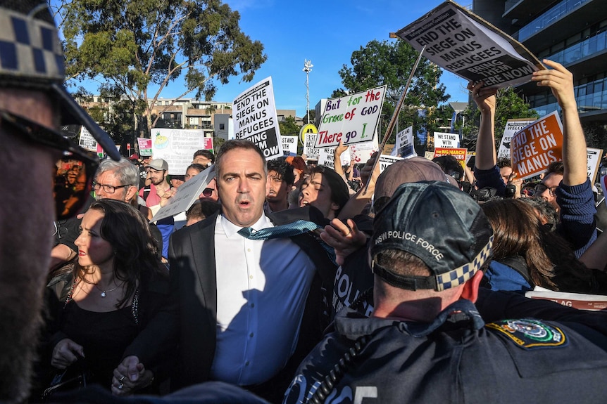 Police, attendees and protesters clash.