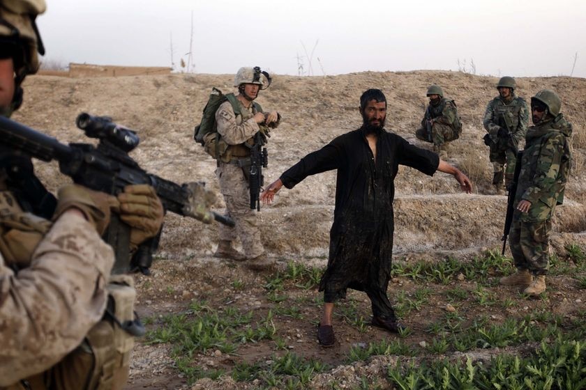 US troops  guard a man suspected to be a Taliban spotter. (Patrick Baz: AFP)