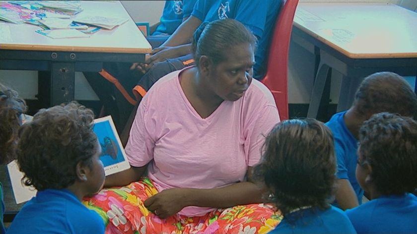 A teacher reads to children in Wadeye.