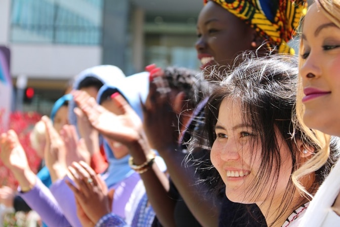 Colour photograph of women with heritage from Africa and Asia at a multicultural fashion festival in Tasmania