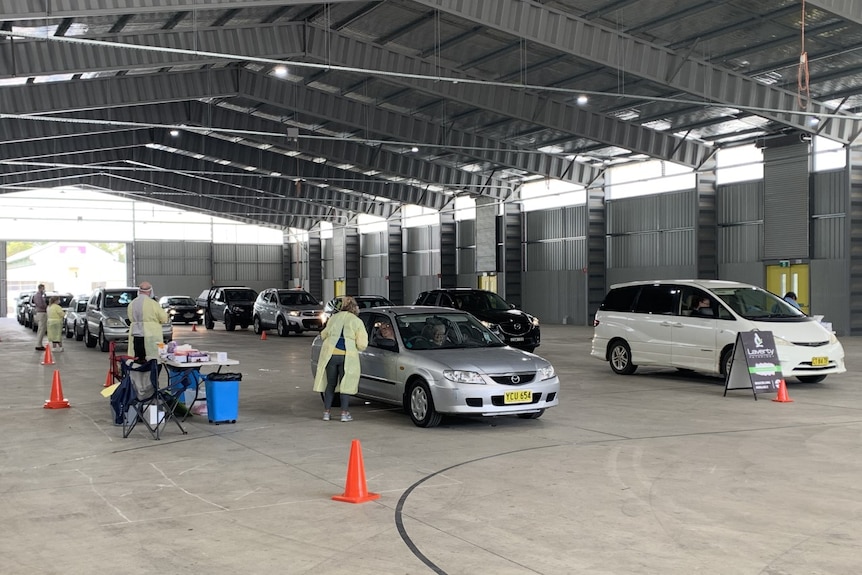 Cars lining up under cover at a COVID-19 testing clinic in the central NSW town of Orange