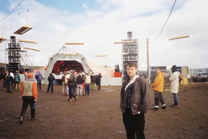 man standing at outdoor festival