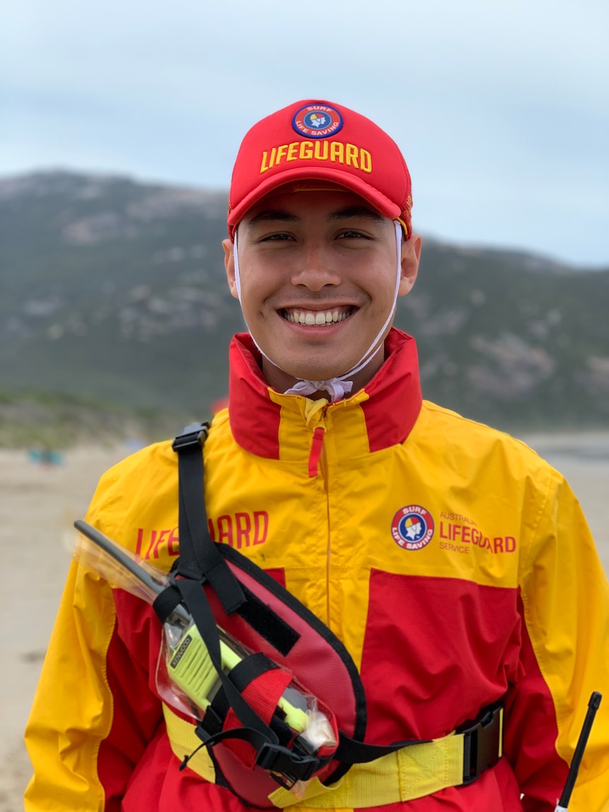 A young man in his professional Lifeguard uniform