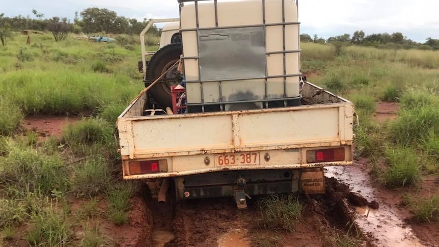 A ute gets bogged in a paddock at Tennant Creek