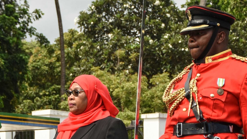The new Tanzanian President Samia Suluhu Hassan inspects a military honour guard as the country's first female President.