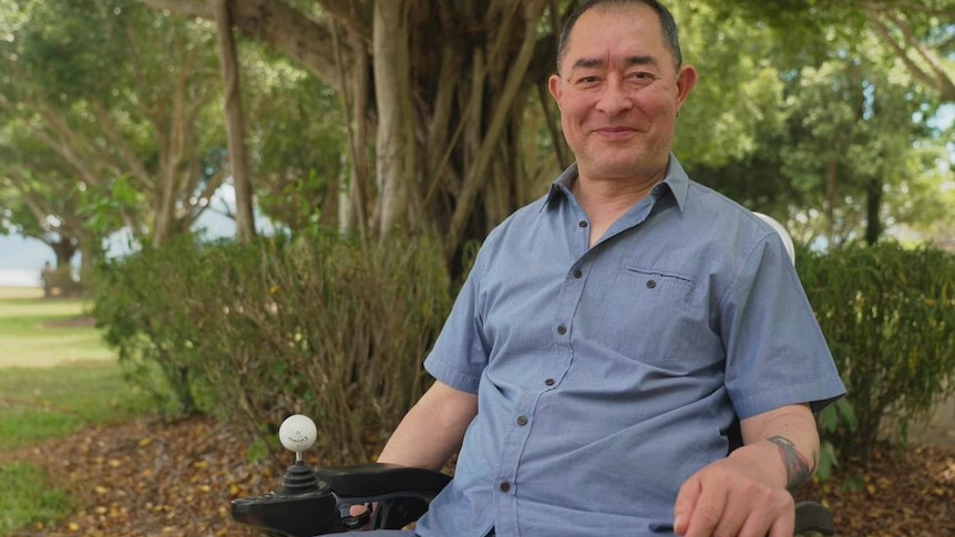 Martin Heng smiling while outside surrounded by trees