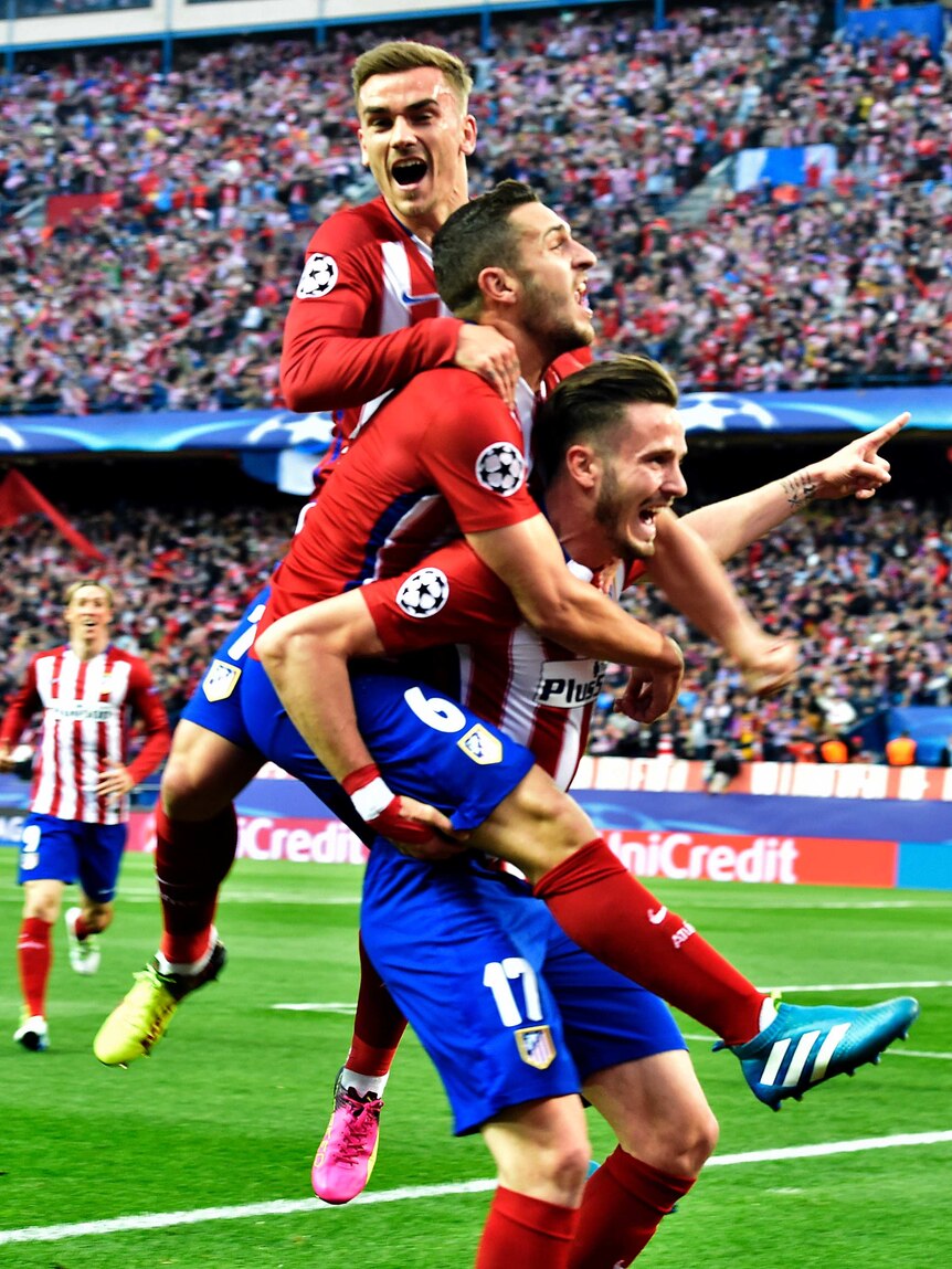 Saul Niguez is mobbed by Atletico team-mates after goal against Bayern