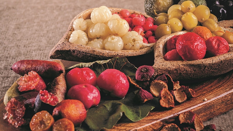 A platter covered in native fruit like finger limes and berries.