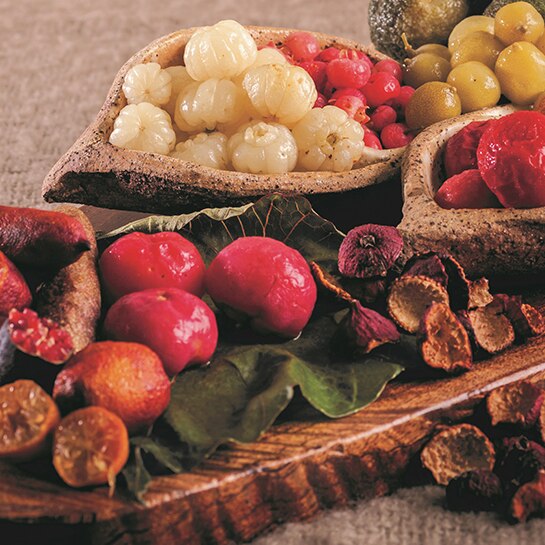 A platter covered in native fruit like finger limes and berries.