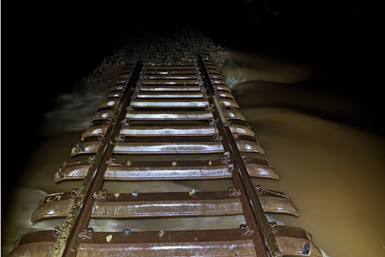 a railway line partially submerged in water. 