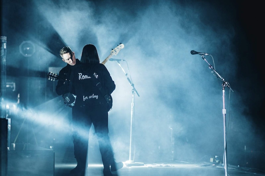 Romy and Oliver from The xx play guitar and bass on stage at Splendour In The Grass 2017