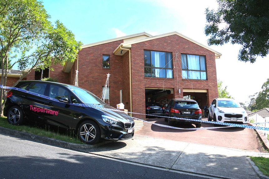 Police tape surrounds a brick house, with a 'Tupperware' care parked on the lawn out the front.