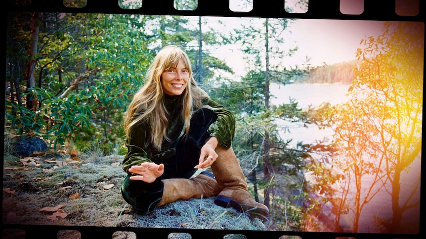 Joni Mitchell on the cover of her LP 'For The Roses', she's sitting in the forest next to a river