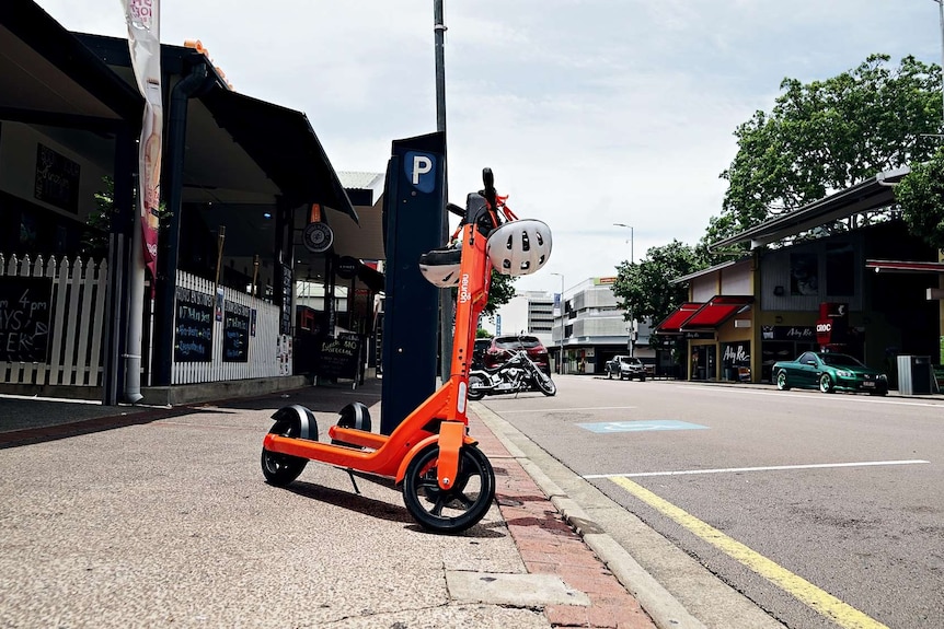 Two scooters are parked on a footpath on Mitchell Street in the Darwin CBD.