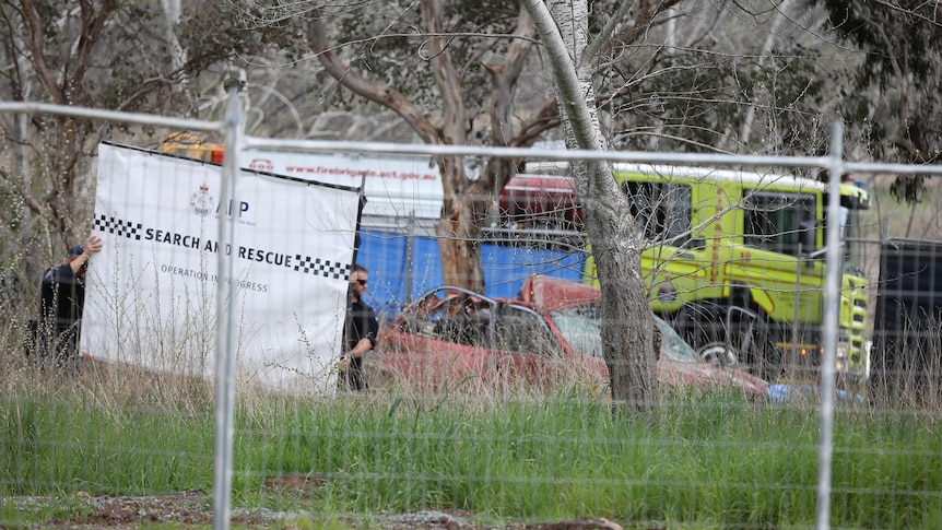 Fencing surrounding a crashed car. 