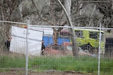 Fencing surrounding a crashed car. 