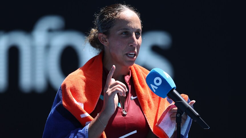 American tennis player Madison Keys speaks into a microphone.