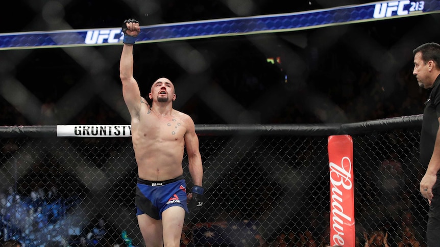 Robert Whittaker celebrates after defeating Yoel Romero in a middleweight MMA bout at UFC 213.