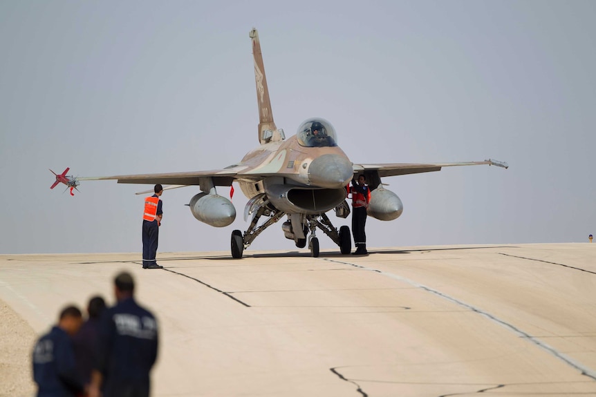 Wide shot of a jet on a runway.