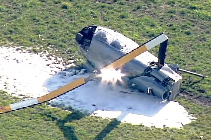 Fire retardant foam around a large piece of helicopter debris including a bent propeller.