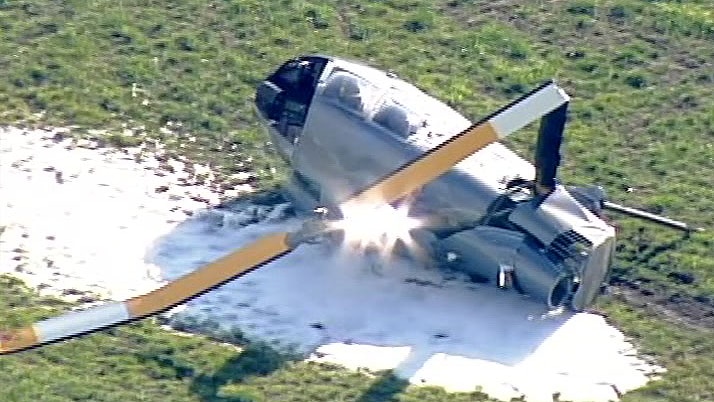 Fire retardant foam around a large piece of helicopter debris including a bent propeller.