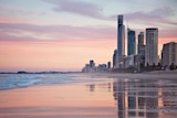 Gold Coast beach and high-rise building skyline during sunset.
