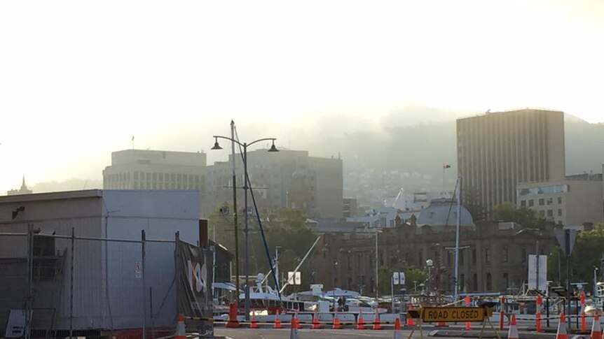 Christmas Eve fog rolls in over the CBD, seen from Hobart's waterfront.