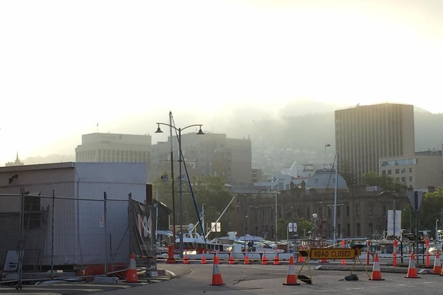 Christmas Eve fog rolls in over the CBD, seen from Hobart's waterfront.