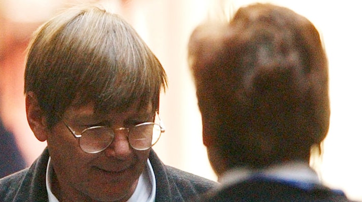 A file photograph of Peter Dupas, with brown hair and glasses.