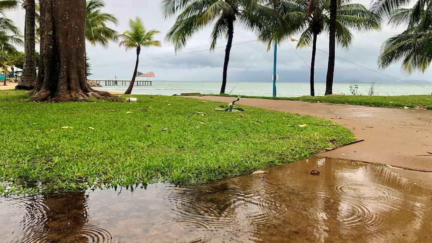 Rain was still falling at The Strand in Townsville this morning.