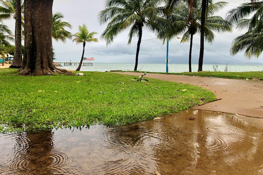 Rain was still falling at The Strand in Townsville this morning.