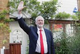Labour leader Jeremy Corbyn waves as he leaves his leafy home in north London.
