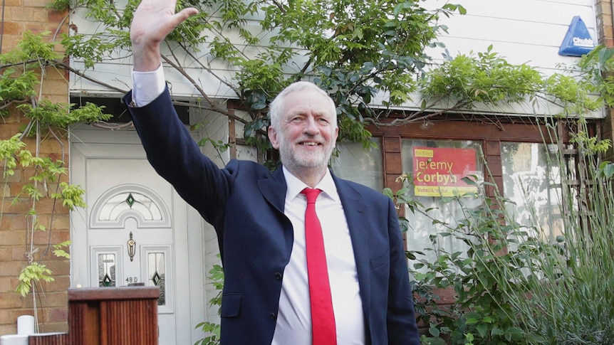 Labour leader Jeremy Corbyn waves as he leaves his leafy home in north London.