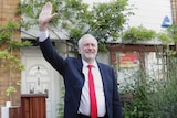 Labour leader Jeremy Corbyn waves as he leaves his leafy home in north London.