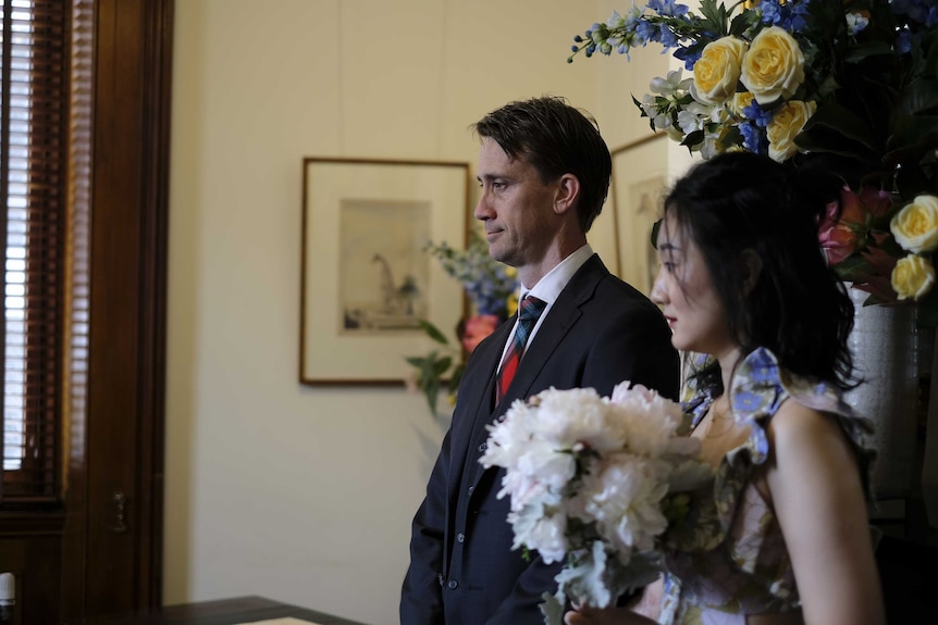 Zixun Wang and her husband Lachlan Maclaine-Cross at a ceremony.