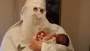Neo-Nazi parent holds son dressed as KKK member