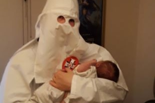 Neo-Nazi parent holds son dressed as KKK member