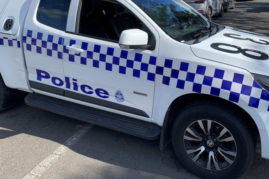 A police car blocking off a street.