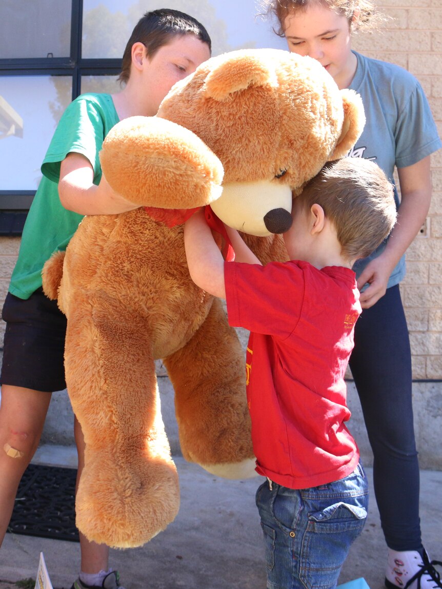 Children with giant bear.