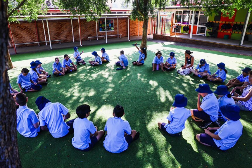 students sitting in a circle on the playground