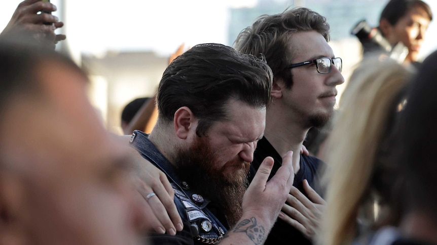 A man is comforted by a friend during a vigil in Las Vegas for victims of the mass shooting.