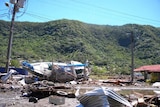 A yacht lies stricken after being washed inland by a tsunami that hit American Samoa
