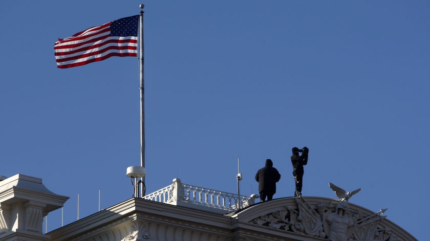 Secret Service agents provide security for US President-elect Barack Obama from the top of the Eisenhower Executive Office Building in Washington.