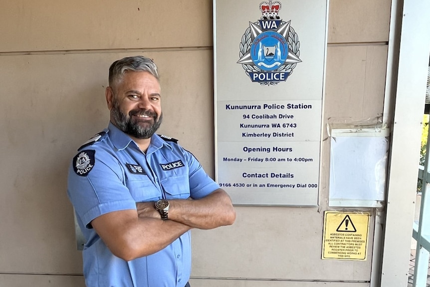A police sergeant standing outside a police station
