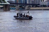 Police divers looking for clues in the Brisbane River in murder investigation