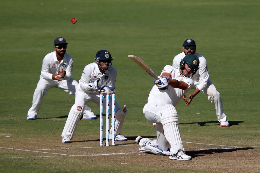 Mitchell Starc slogs on day one against India