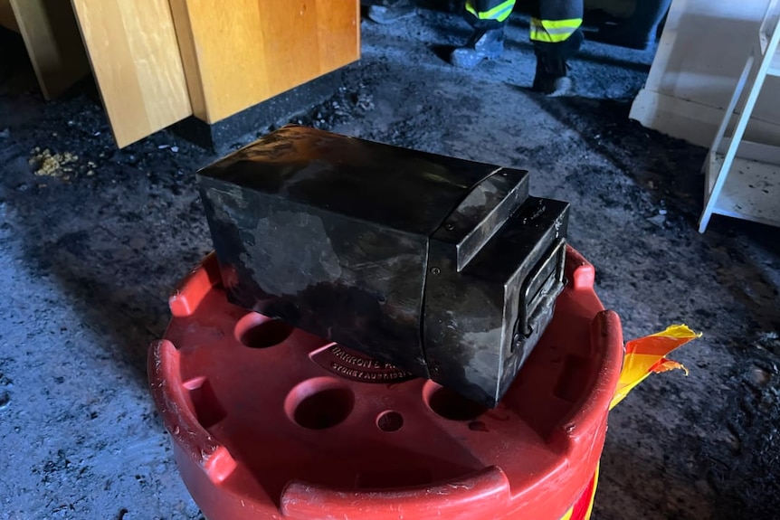 Charred remains of faulty lithium-ion battery that caused a unit fire in bondi